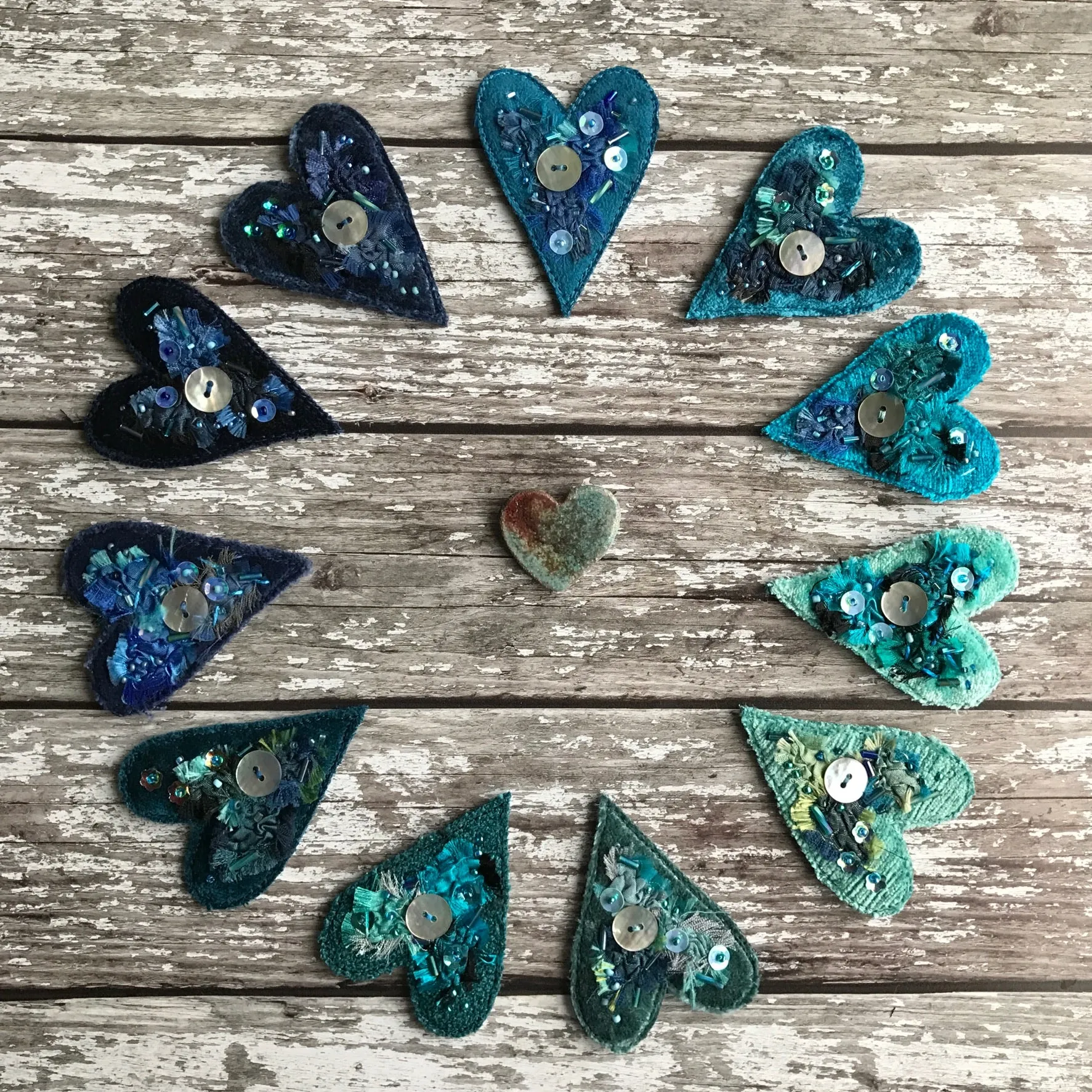 Fabric heart brooches in blues