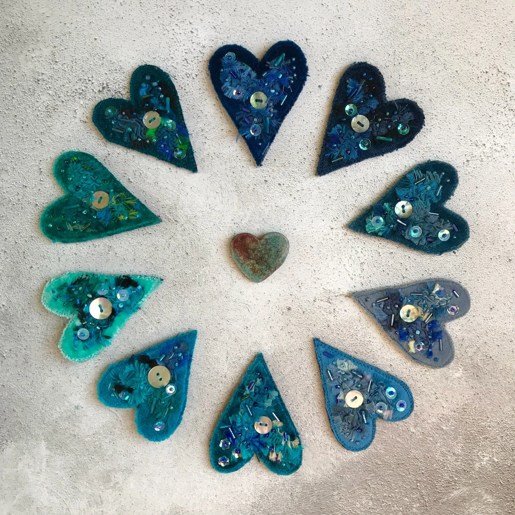 Fabric heart brooches in blues